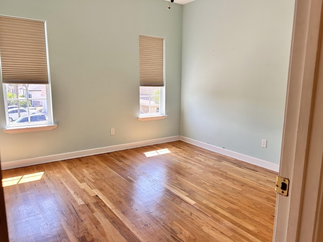 unfurnished room with plenty of natural light and light hardwood / wood-style flooring