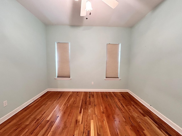 spare room featuring wood-type flooring and ceiling fan