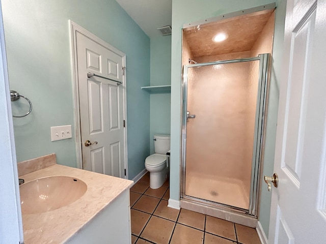 bathroom with vanity, toilet, tile patterned flooring, and a shower with door