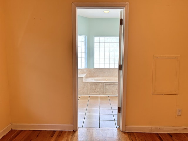 corridor with light wood-type flooring