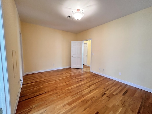 spare room with light hardwood / wood-style flooring