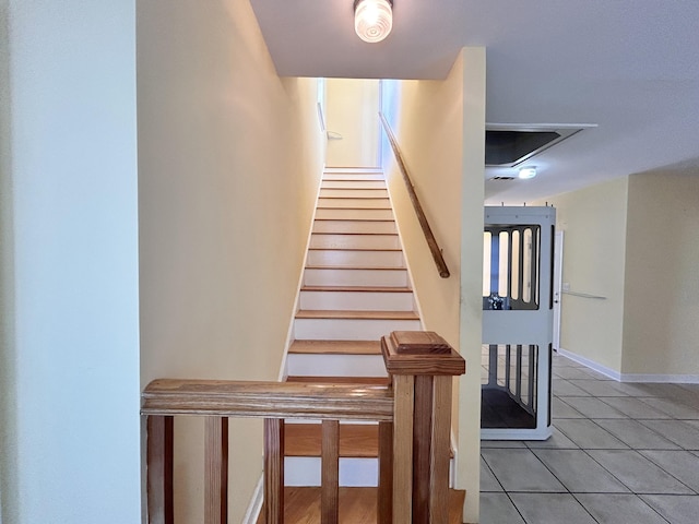 stairs with tile patterned flooring