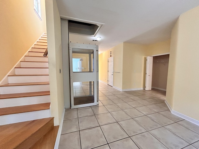 stairs with tile patterned floors