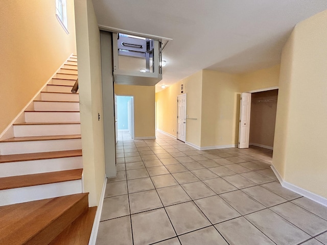 stairway featuring tile patterned flooring