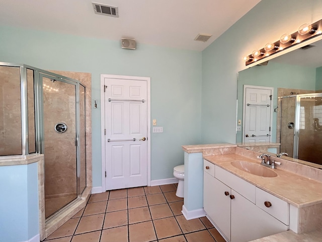 bathroom featuring vanity, toilet, an enclosed shower, and tile patterned flooring