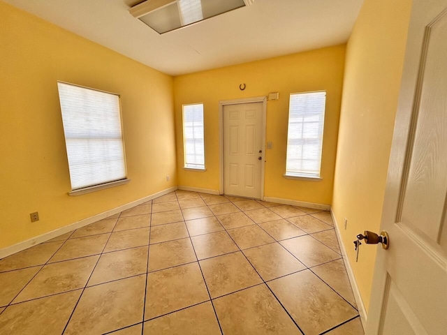 foyer with plenty of natural light and light tile patterned floors