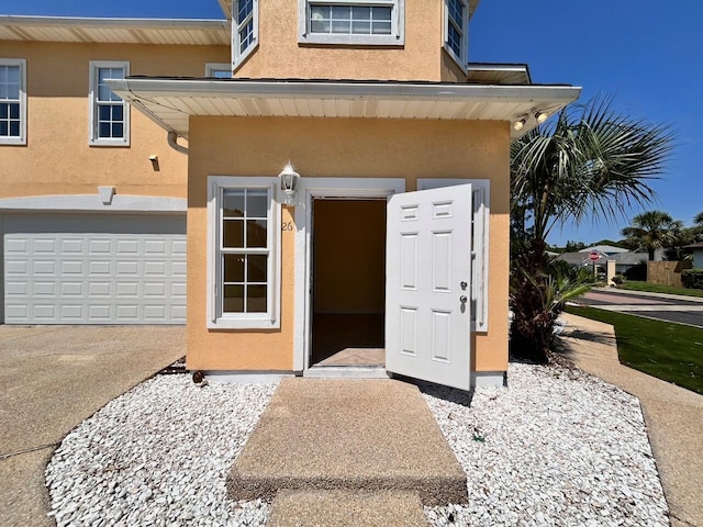 view of exterior entry featuring a garage