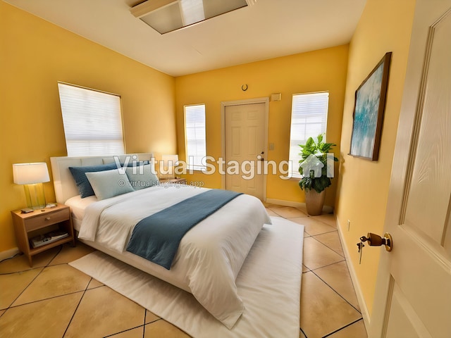 tiled bedroom with multiple windows