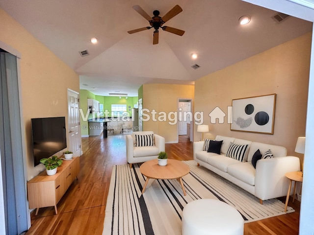 living room with wood-type flooring, high vaulted ceiling, and ceiling fan