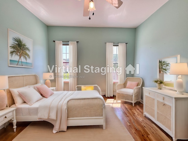 bedroom featuring multiple windows and light hardwood / wood-style flooring