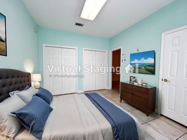 tiled bedroom with multiple closets