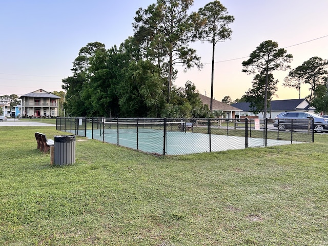 view of sport court with a yard