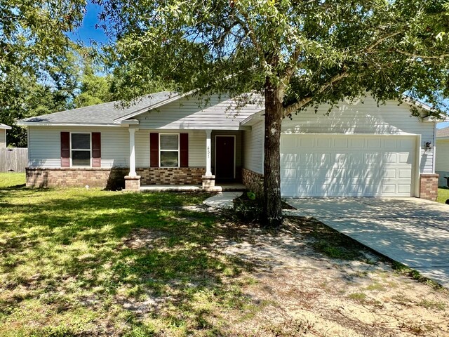 ranch-style house with a garage and a front lawn