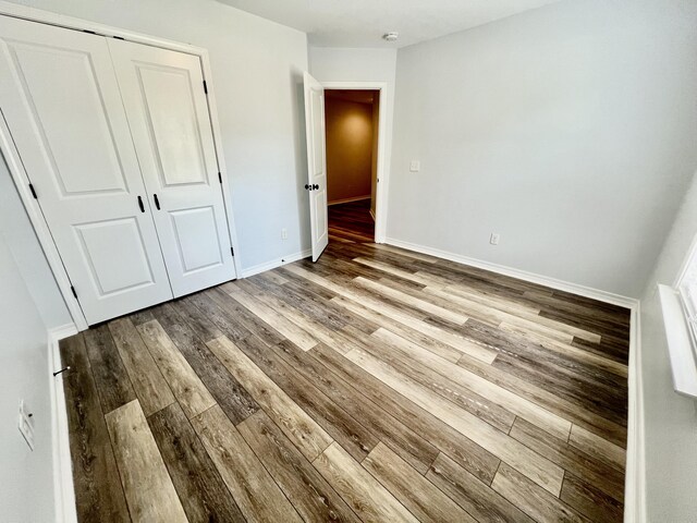 unfurnished bedroom featuring a closet and light hardwood / wood-style flooring