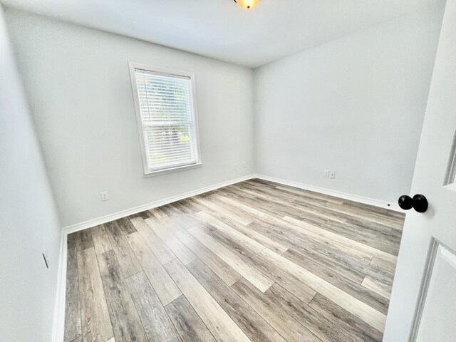 spare room featuring light wood-type flooring