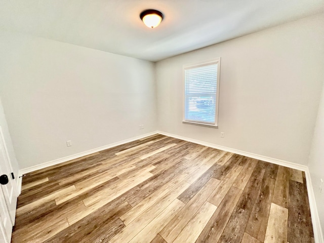 spare room featuring wood-type flooring