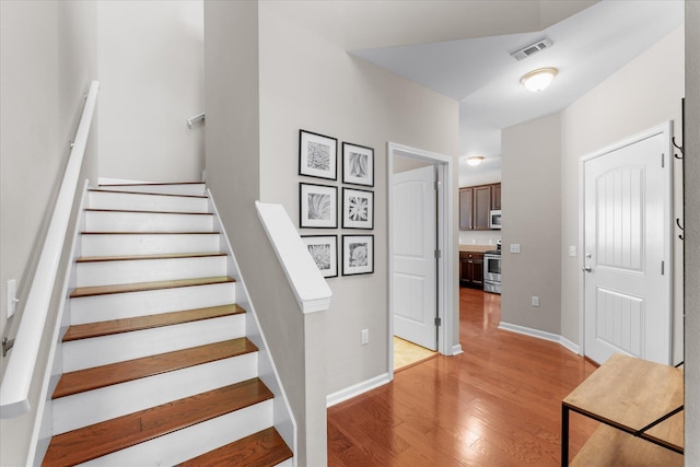 stairs with hardwood / wood-style floors