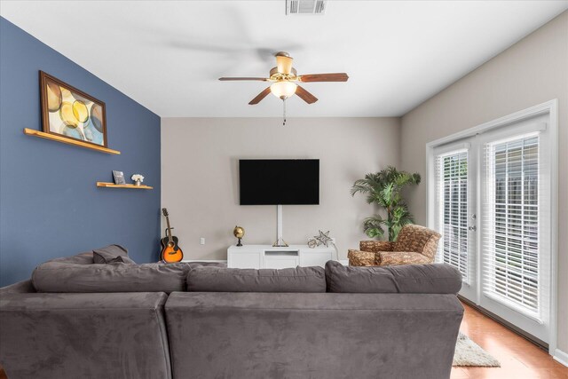 living room with ceiling fan and wood-type flooring