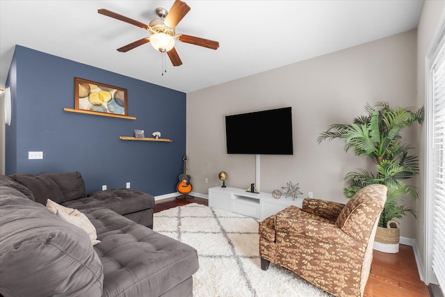 living room featuring ceiling fan and wood-type flooring