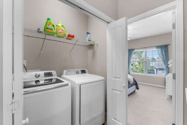 washroom featuring light carpet and washer and dryer