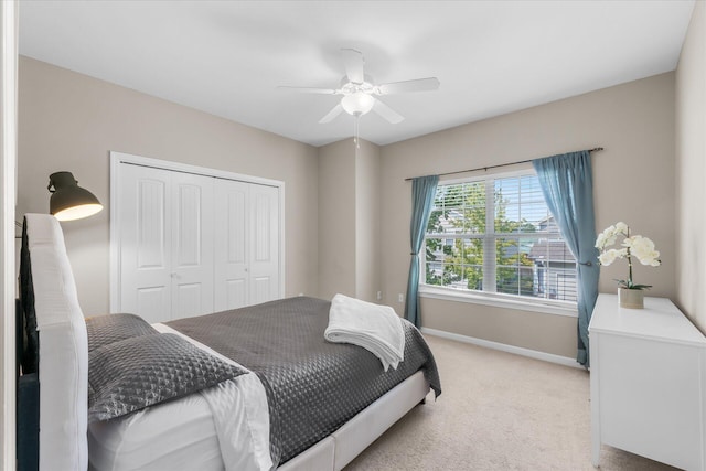 carpeted bedroom featuring a closet and ceiling fan