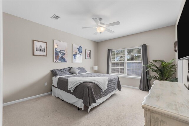 bedroom with ceiling fan and light carpet