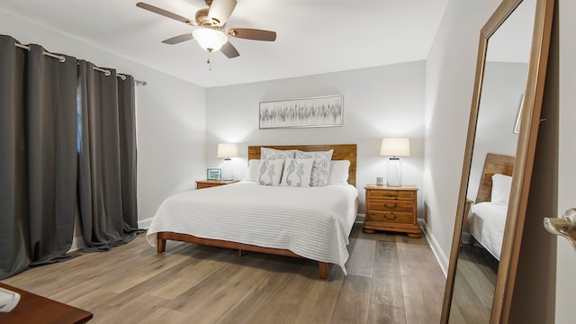 bedroom with ceiling fan and light hardwood / wood-style flooring