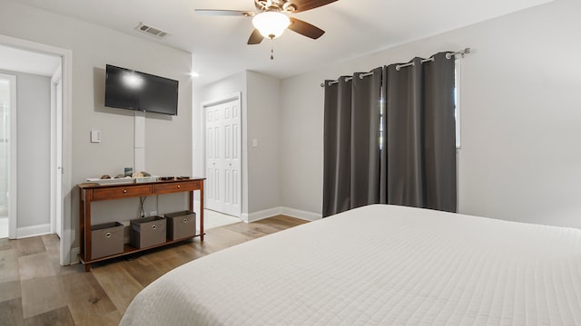 bedroom featuring a closet, ceiling fan, and hardwood / wood-style flooring