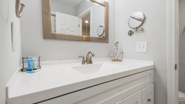 bathroom with toilet and vanity