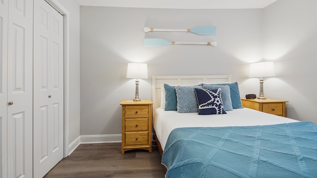 bedroom with a closet and dark hardwood / wood-style flooring