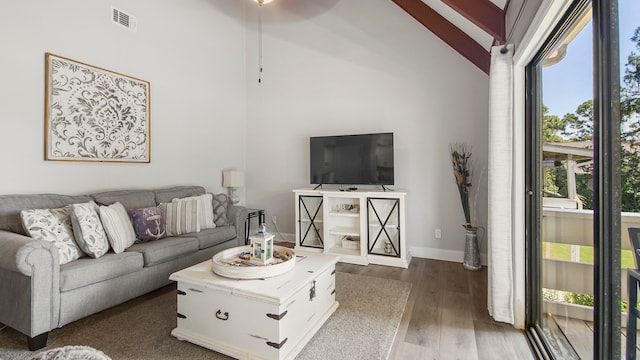 living room with beam ceiling, high vaulted ceiling, and dark hardwood / wood-style floors