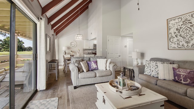 living room featuring high vaulted ceiling, hardwood / wood-style floors, and beamed ceiling