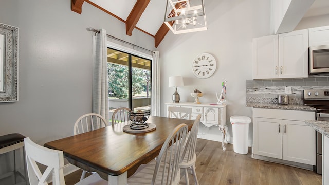 dining room with beam ceiling, light hardwood / wood-style floors, high vaulted ceiling, and an inviting chandelier