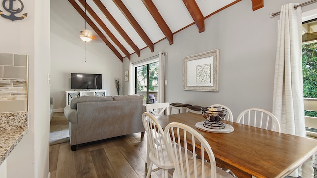 dining space featuring beam ceiling, high vaulted ceiling, and wood-type flooring