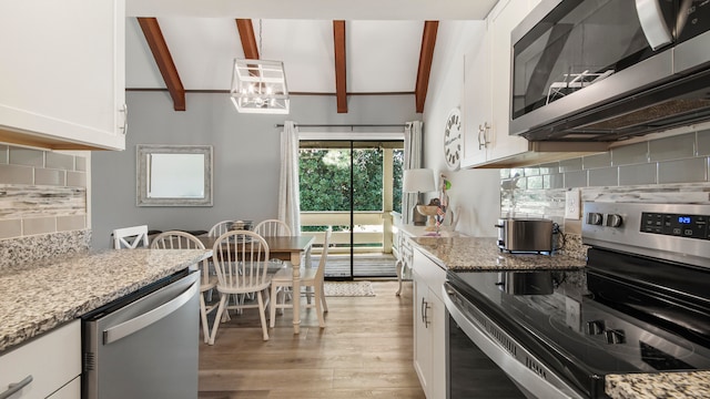 kitchen featuring vaulted ceiling with beams, decorative backsplash, white cabinets, light hardwood / wood-style floors, and stainless steel appliances