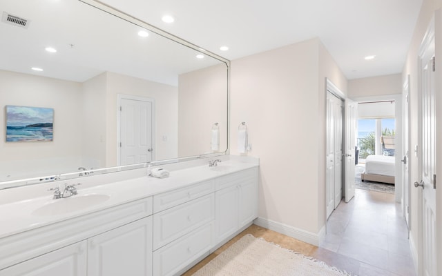 bathroom with dual bowl vanity and tile patterned floors