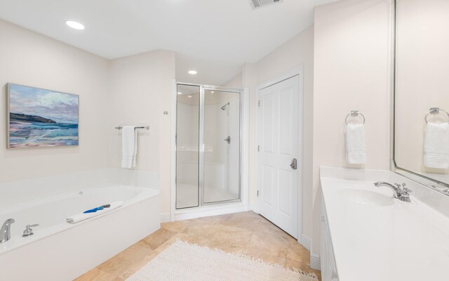 bathroom featuring tile patterned floors, vanity, and separate shower and tub