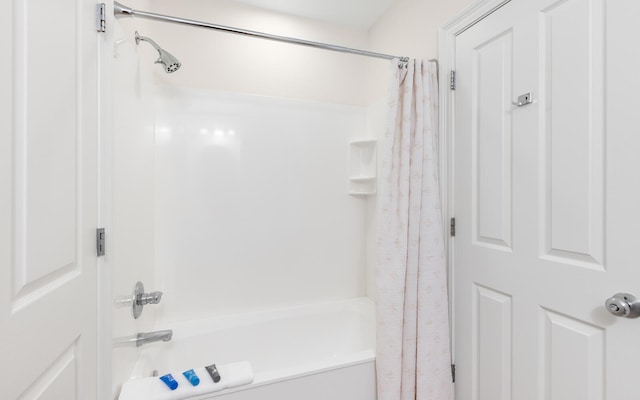 bathroom with shower / bath combination with curtain