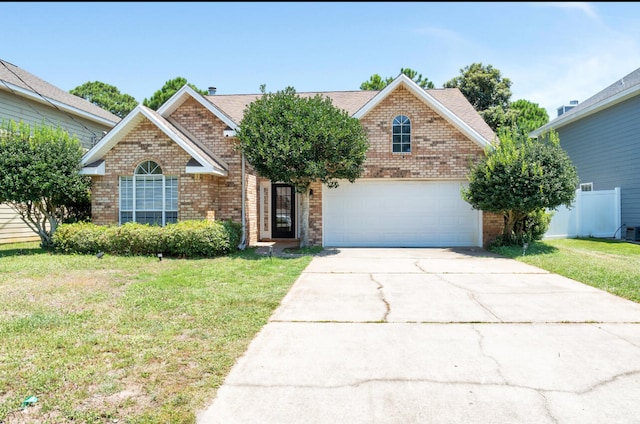 front of property with a front yard and a garage