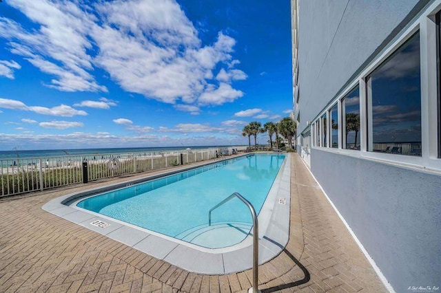 view of pool with a water view