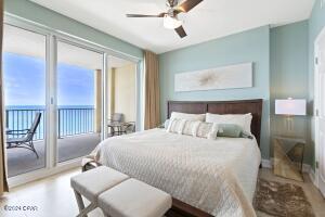 bedroom featuring hardwood / wood-style floors, ceiling fan, and access to exterior