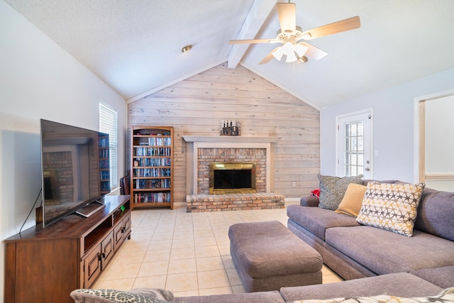 tiled living room with wood walls, vaulted ceiling with beams, a healthy amount of sunlight, and a brick fireplace