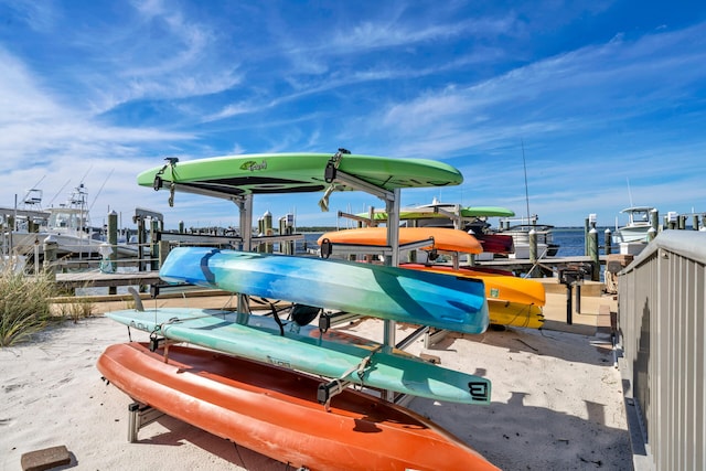 dock area with a water view and boat lift