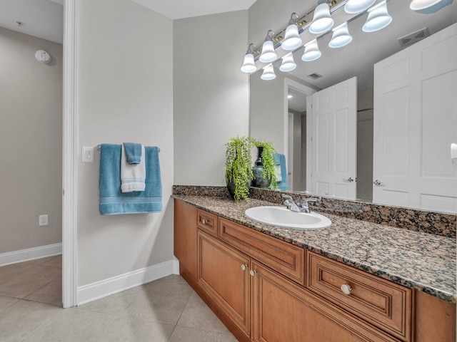 bathroom with tile patterned flooring, visible vents, vanity, and baseboards