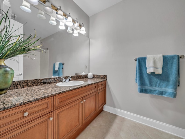 bathroom with tile patterned flooring, vanity, and baseboards