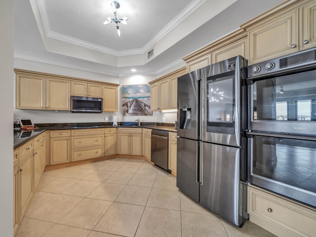 kitchen featuring light tile patterned flooring, a sink, visible vents, appliances with stainless steel finishes, and a raised ceiling