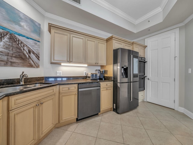 kitchen featuring light tile patterned floors, a sink, ornamental molding, appliances with stainless steel finishes, and a tray ceiling