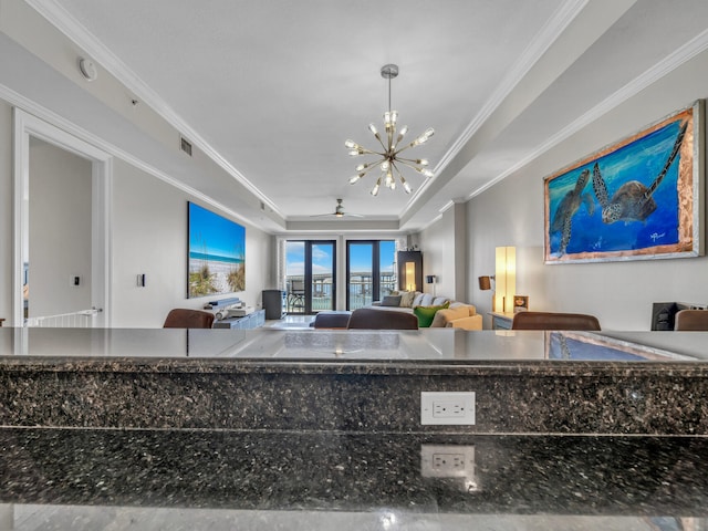 kitchen featuring open floor plan, a tray ceiling, and crown molding