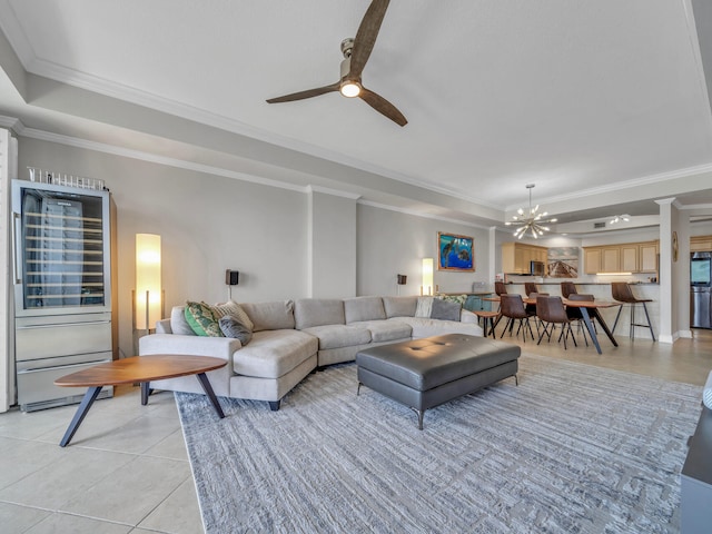 living area featuring light tile patterned floors, ceiling fan with notable chandelier, a raised ceiling, and crown molding