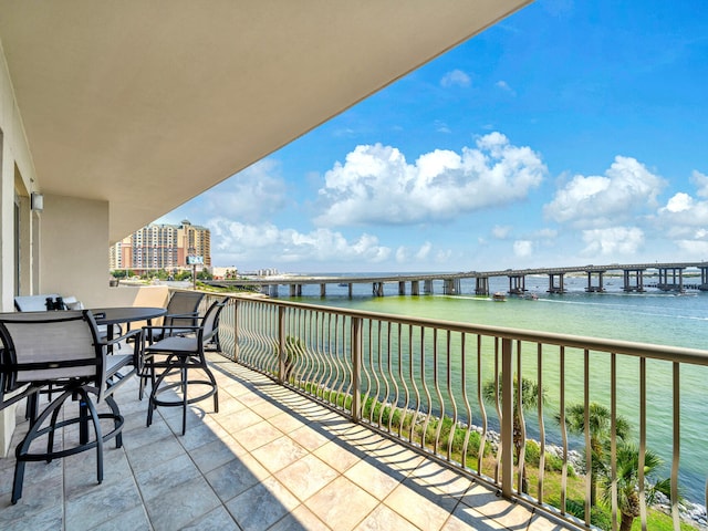 balcony with a water view and a city view